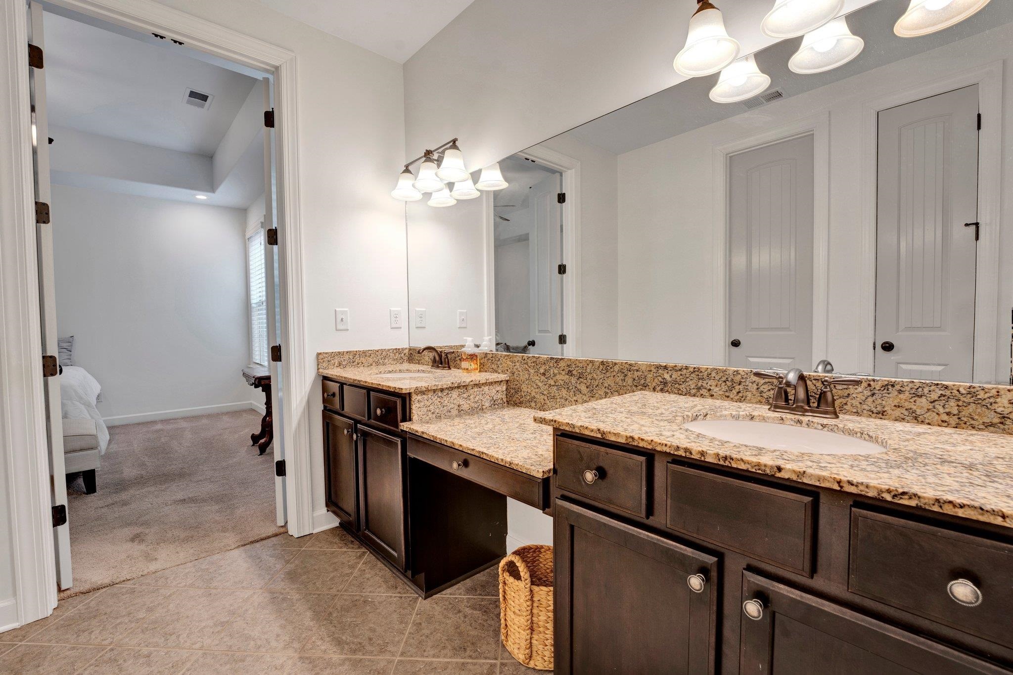 1965 Rochelle Lane Cordova, TN 38016 - Photo 31 of 40 a bathroom with a granite countertop sink and a mirror
