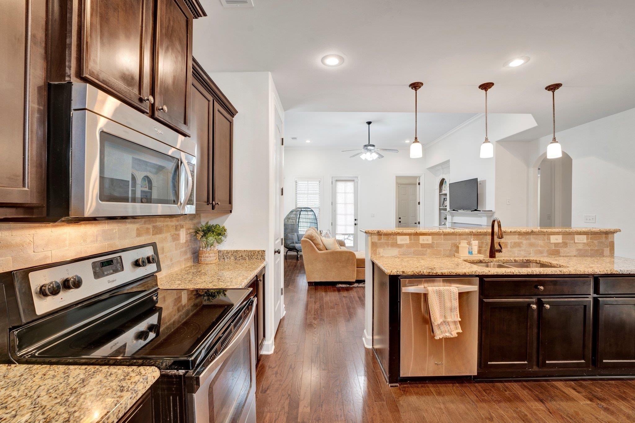1965 Rochelle Lane Cordova, TN 38016 - Photo 4 of 40 a kitchen with stainless steel appliances granite countertop a stove a sink and a refrigerator