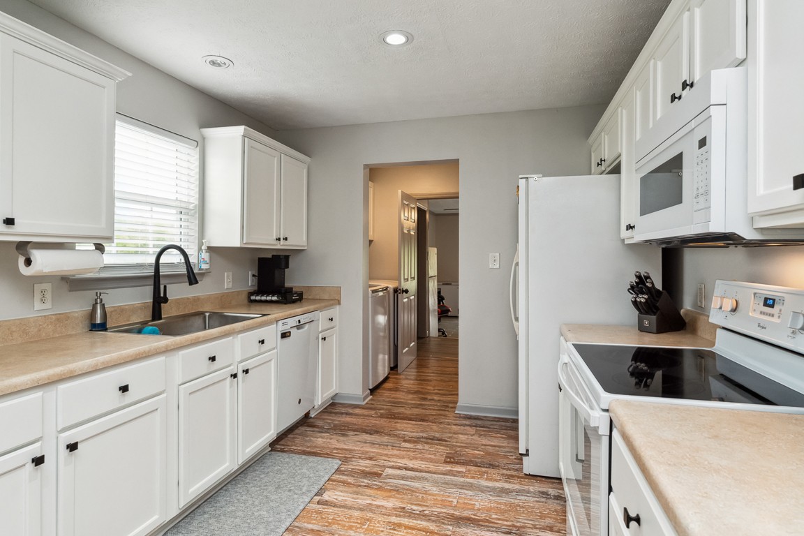 497 Puckett Road Watertown, TN 37184 - Photo 10 of 27 a kitchen with granite countertop a sink and white cabinets