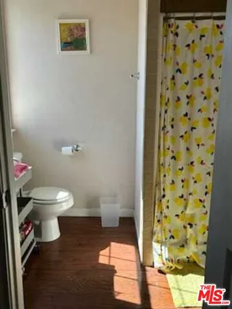 a white toilet sitting next to a bathroom sink