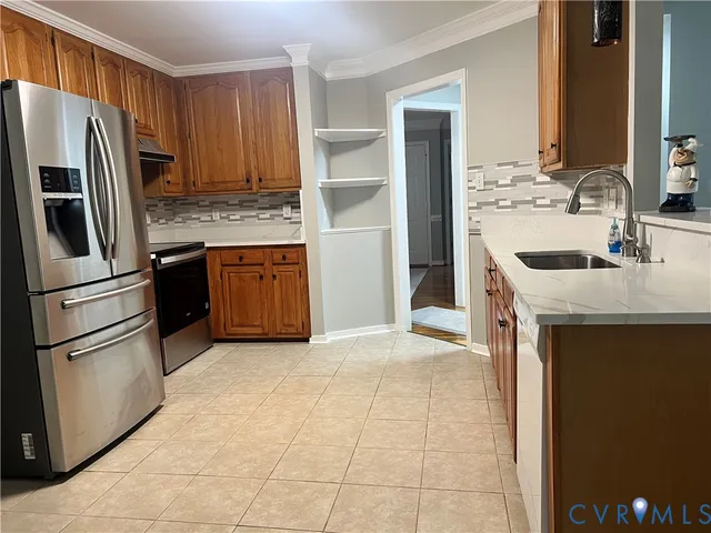 a kitchen with kitchen island granite countertop a sink stove and refrigerator