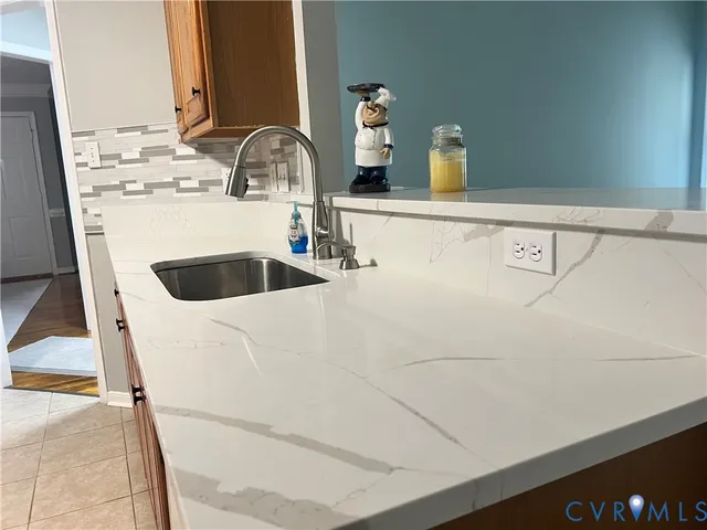 a kitchen with granite countertop stainless steel appliances and wooden cabinets