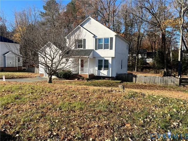 a front view of a house with a yard covered in snow