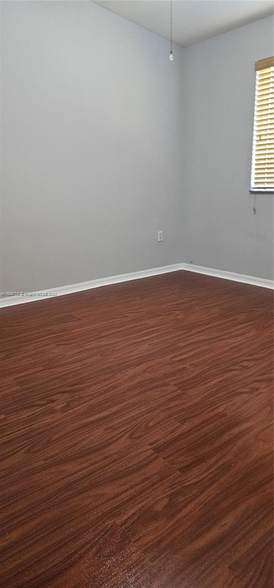 2910 Southeast 12th Road, Unit 20429 Homestead, FL 33035 - Photo 11 of 16 wooden floor in an empty room