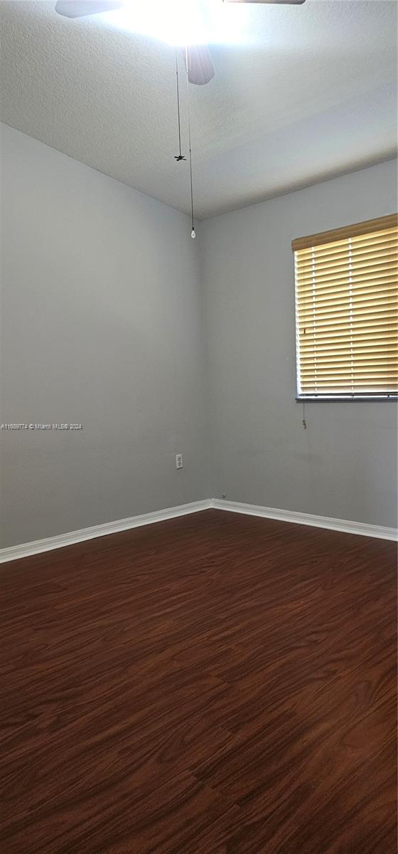 2910 Southeast 12th Road, Unit 20429 Homestead, FL 33035 - Photo 12 of 16 a view of an empty room with wooden floor and a window