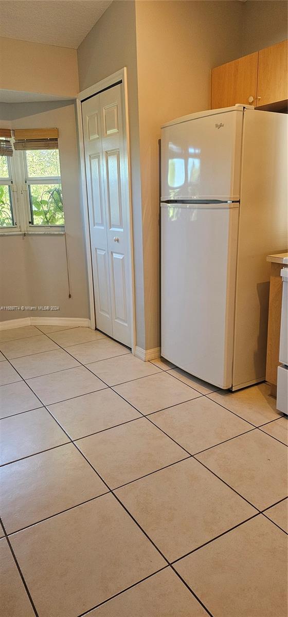 2910 Southeast 12th Road, Unit 20429 Homestead, FL 33035 - Photo 8 of 16 a view of a refrigerator in kitchen and wooden floor