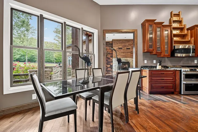 a bedroom with a large bed chandelier and a window