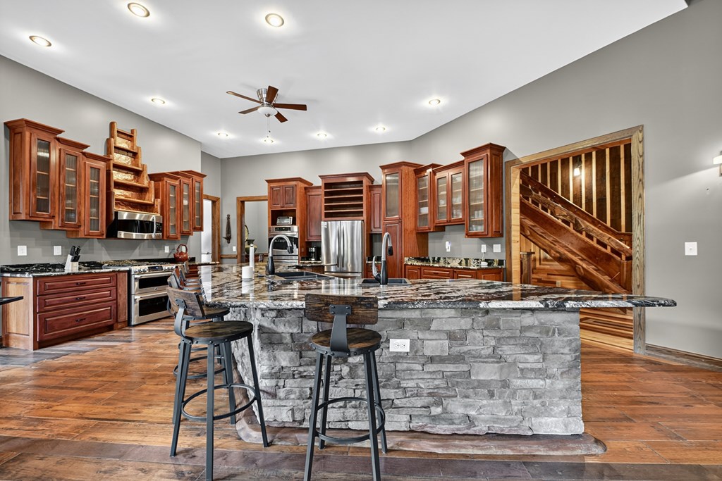 280 Star Creek Crossing Morganton, GA 30560 - Photo 21 of 100 a kitchen with stainless steel appliances kitchen island granite countertop a stove and cabinets