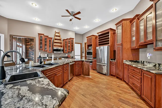 a spacious bathroom with a granite countertop sink and a large mirror