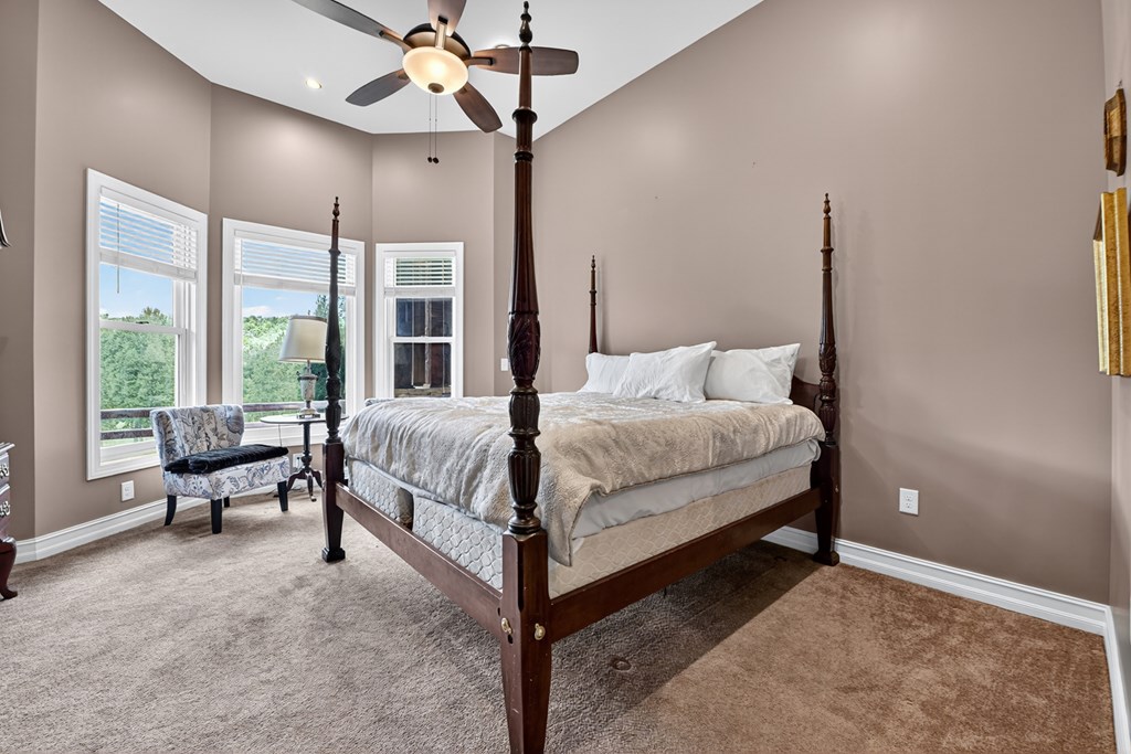 280 Star Creek Crossing Morganton, GA 30560 - Photo 32 of 100 a bedroom with a large bed chandelier and a window