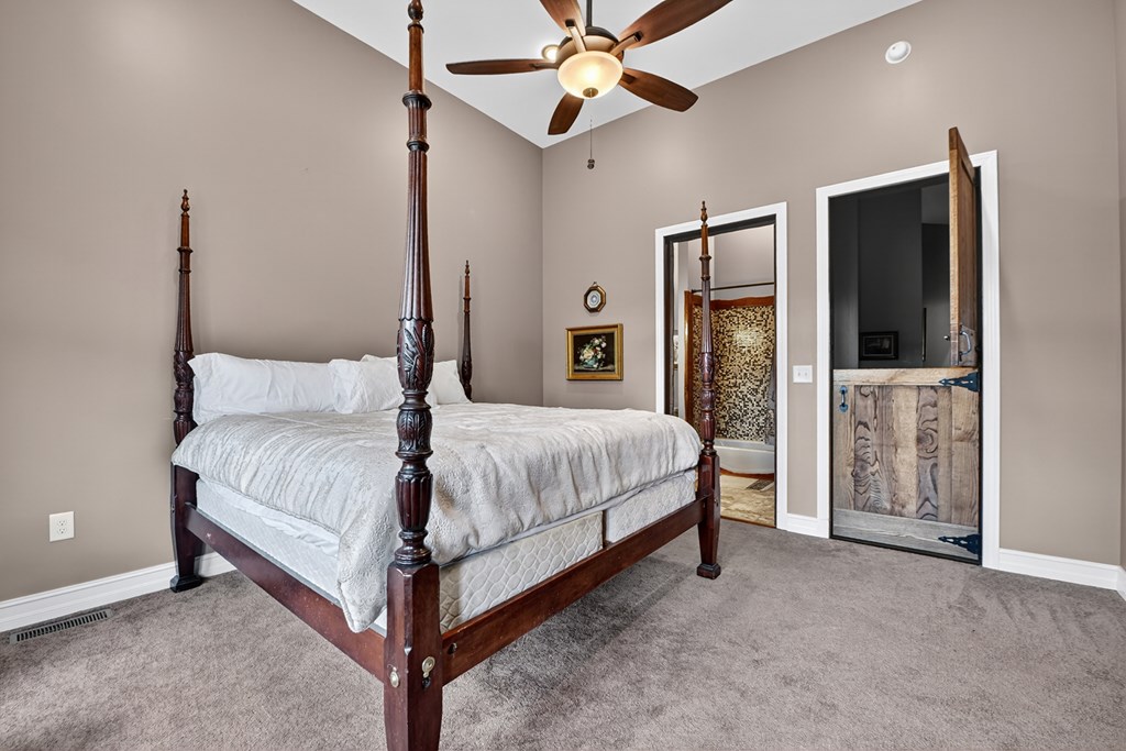 280 Star Creek Crossing Morganton, GA 30560 - Photo 33 of 100 a bedroom with a bed flat screen tv and a walk in closet