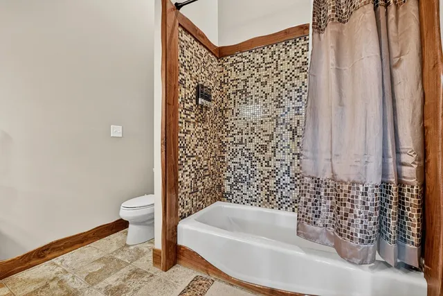 a bathroom with double vanity and a mirror