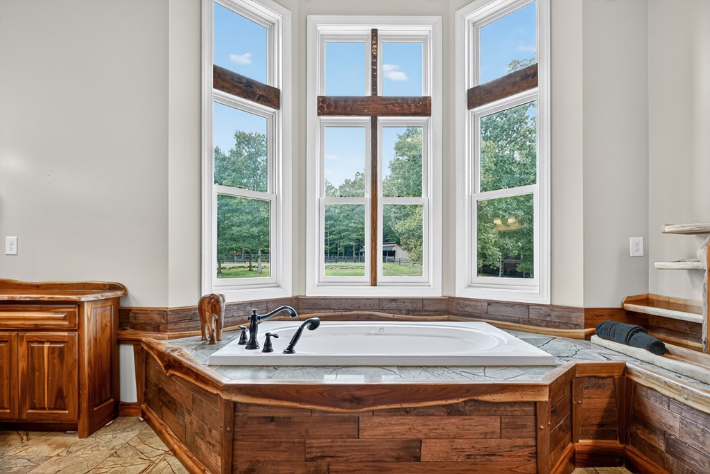 280 Star Creek Crossing Morganton, GA 30560 - Photo 38 of 100 a spacious bathroom with a granite countertop sink and a large mirror