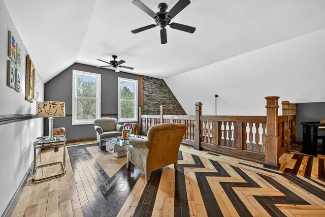 a view of a lush green forest with trees and houses