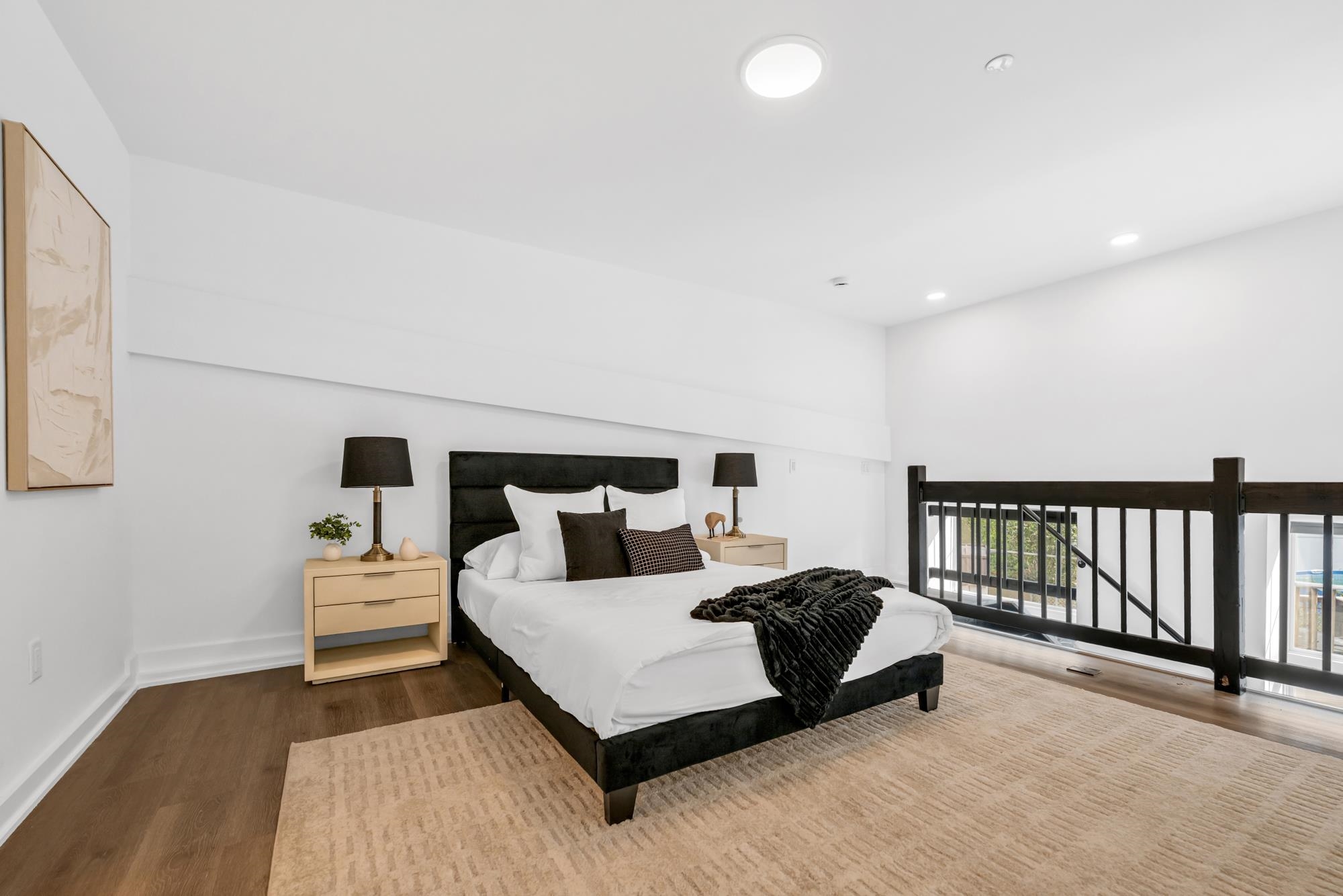 315 Railroad Avenue, Unit 108 East Rutherford, NJ 07073 - Photo 15 of 28 a bedroom with a bed and a night stand