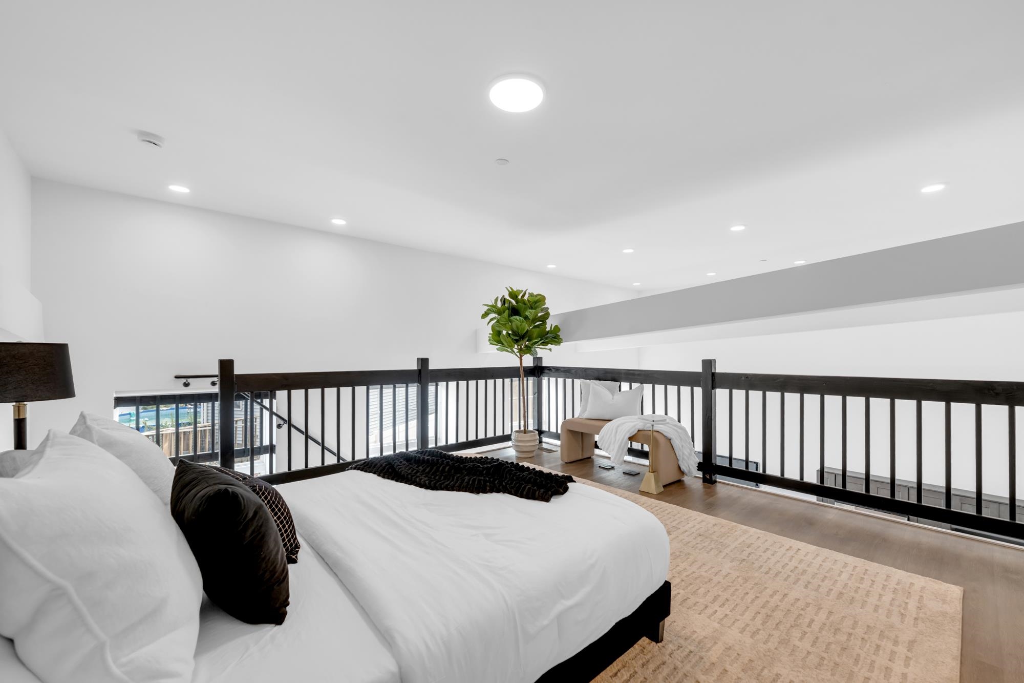 315 Railroad Avenue, Unit 108 East Rutherford, NJ 07073 - Photo 17 of 28 a bedroom with a bed and a chandelier