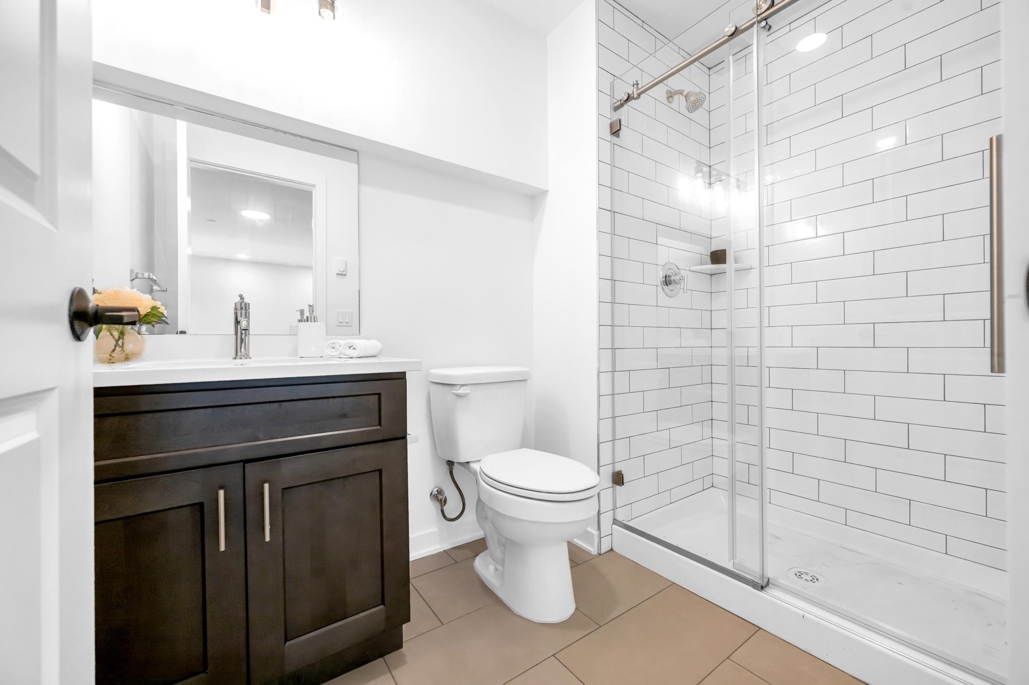 315 Railroad Avenue, Unit 108 East Rutherford, NJ 07073 - Photo 19 of 28 a bathroom with a sink toilet and shower