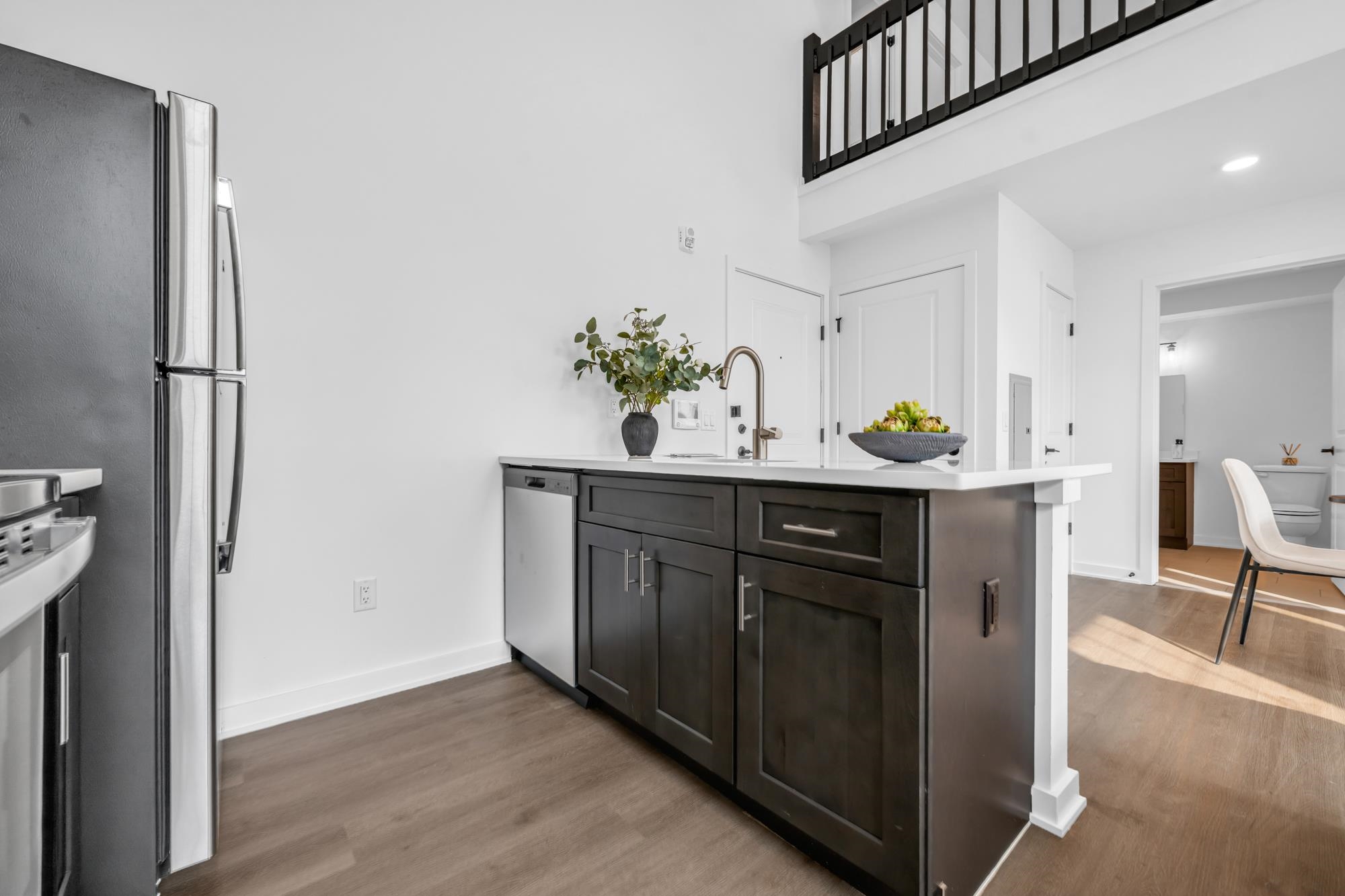 315 Railroad Avenue, Unit 108 East Rutherford, NJ 07073 - Photo 10 of 28 a kitchen with stainless steel appliances a sink a refrigerator and a wooden floor
