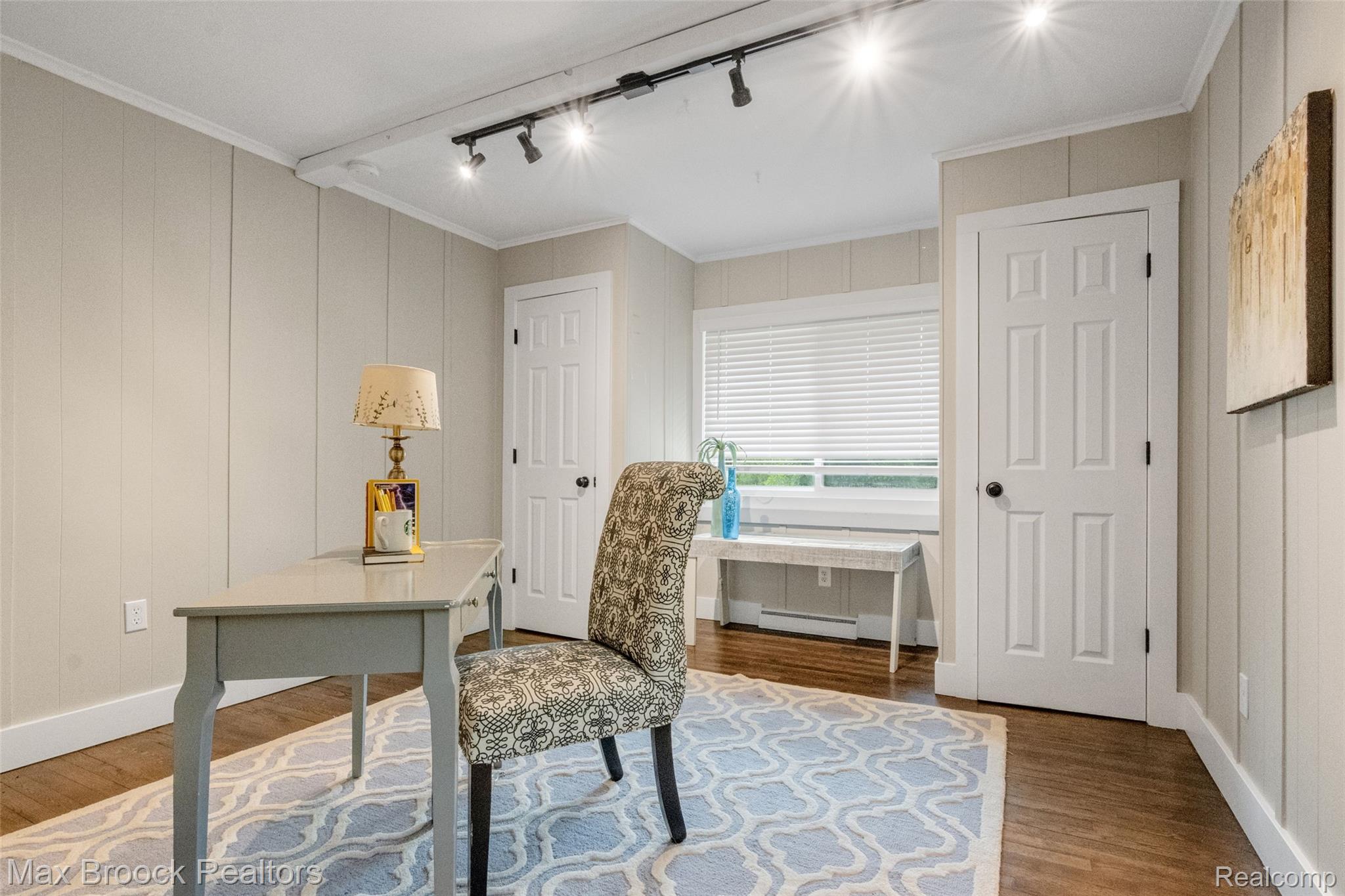 2905 Lahser Road Bloomfield Hills, MI 48304 - Photo 18 of 28 Light-filled room featuring track lighting, wood-finish flooring, paneled walls, and a window with blinds
