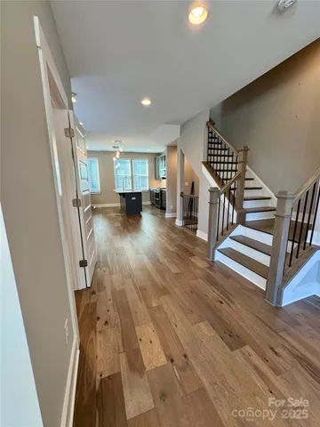 a view of entryway and hall with wooden floor