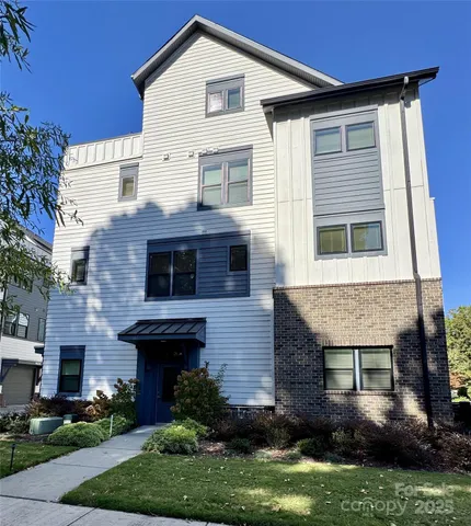 a view of house with yard and green space