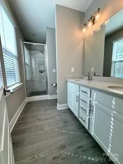 a bathroom with a double vanity sink and a mirror
