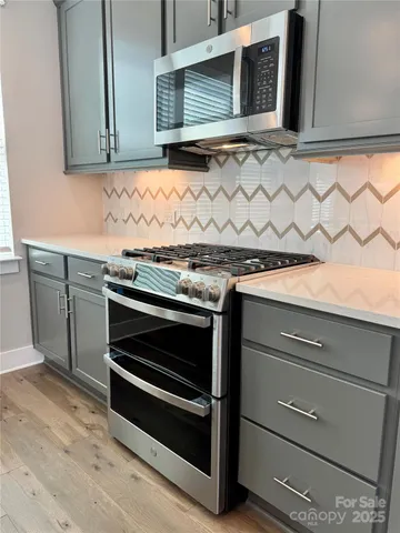 a kitchen with granite countertop cabinets and oven