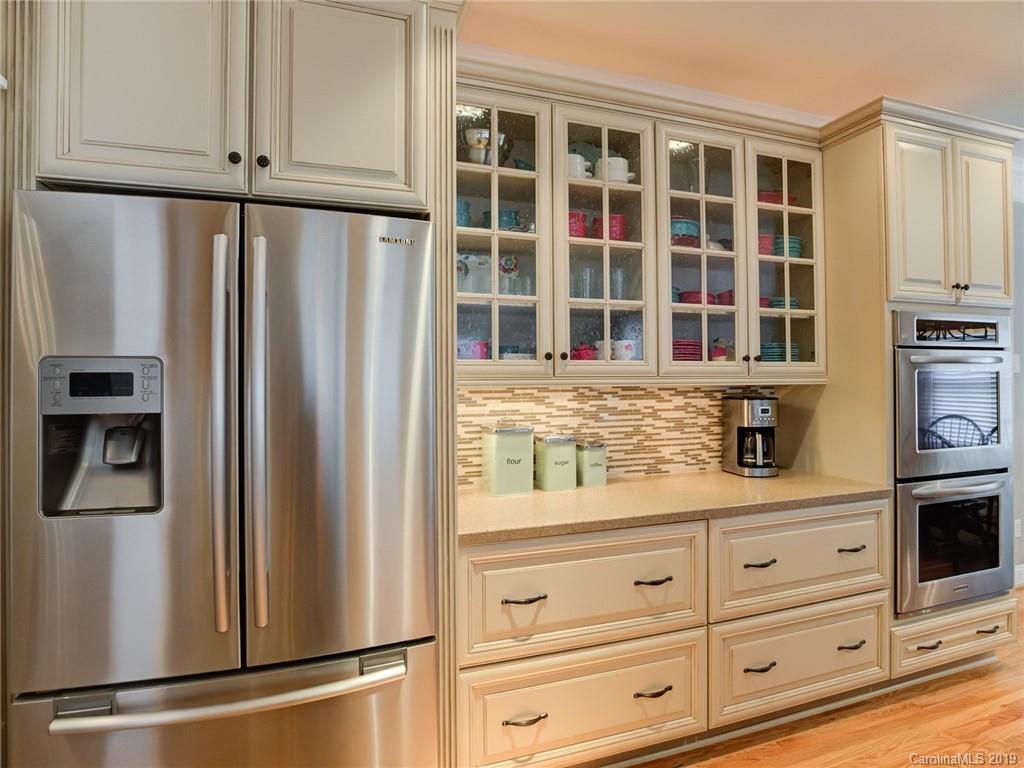 1502 Hubbard Court Fort Mill, SC 29708 - Photo 11 of 36 a kitchen with granite countertop cabinets stainless steel appliances and wooden floor