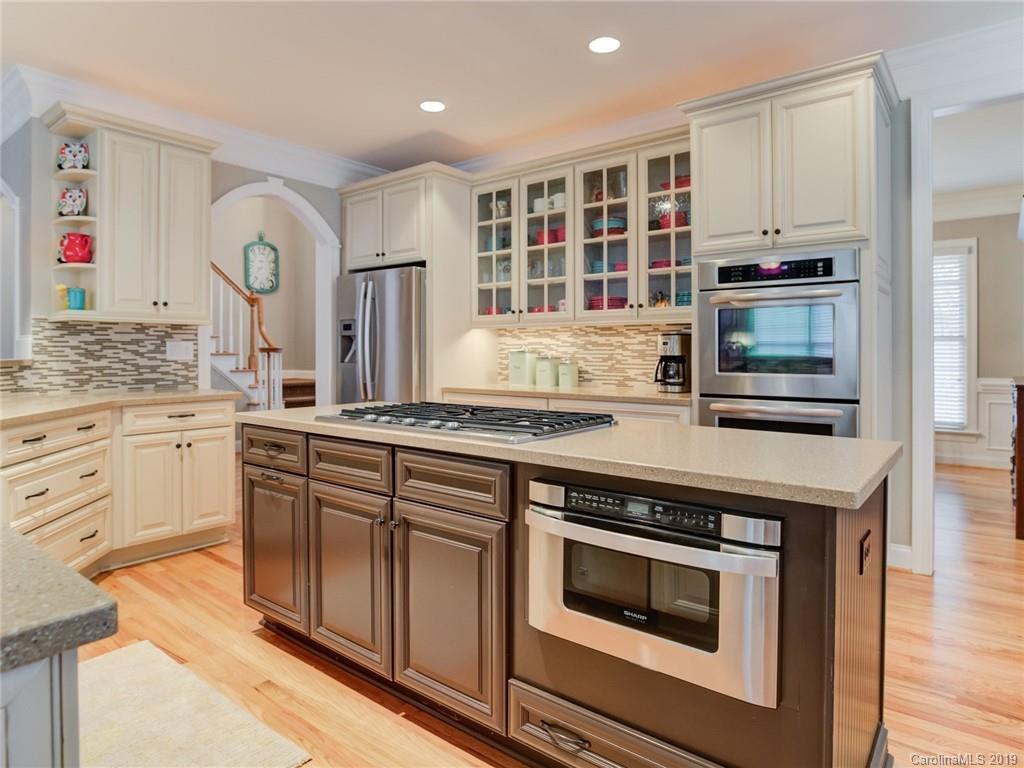 1502 Hubbard Court Fort Mill, SC 29708 - Photo 12 of 36 a kitchen with stainless steel appliances granite countertop a stove and cabinets