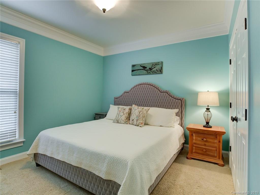 1502 Hubbard Court Fort Mill, SC 29708 - Photo 16 of 36 a bedroom with a bed and a lamp