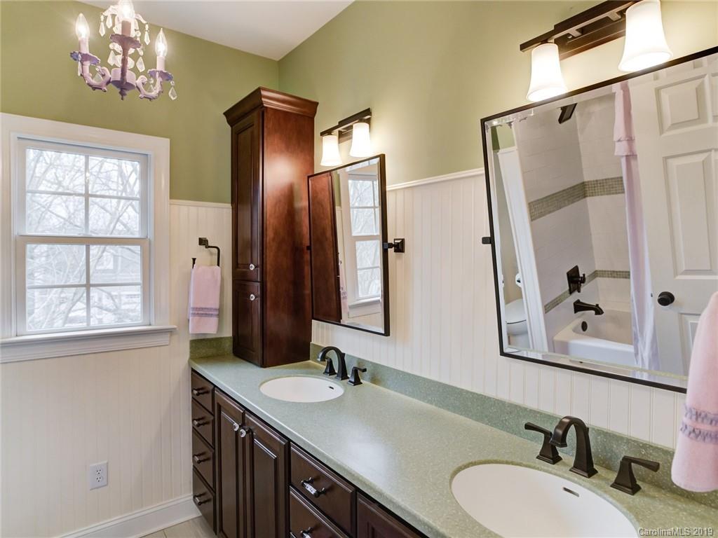 1502 Hubbard Court Fort Mill, SC 29708 - Photo 20 of 36 a bathroom with double vanity sinks and a mirror