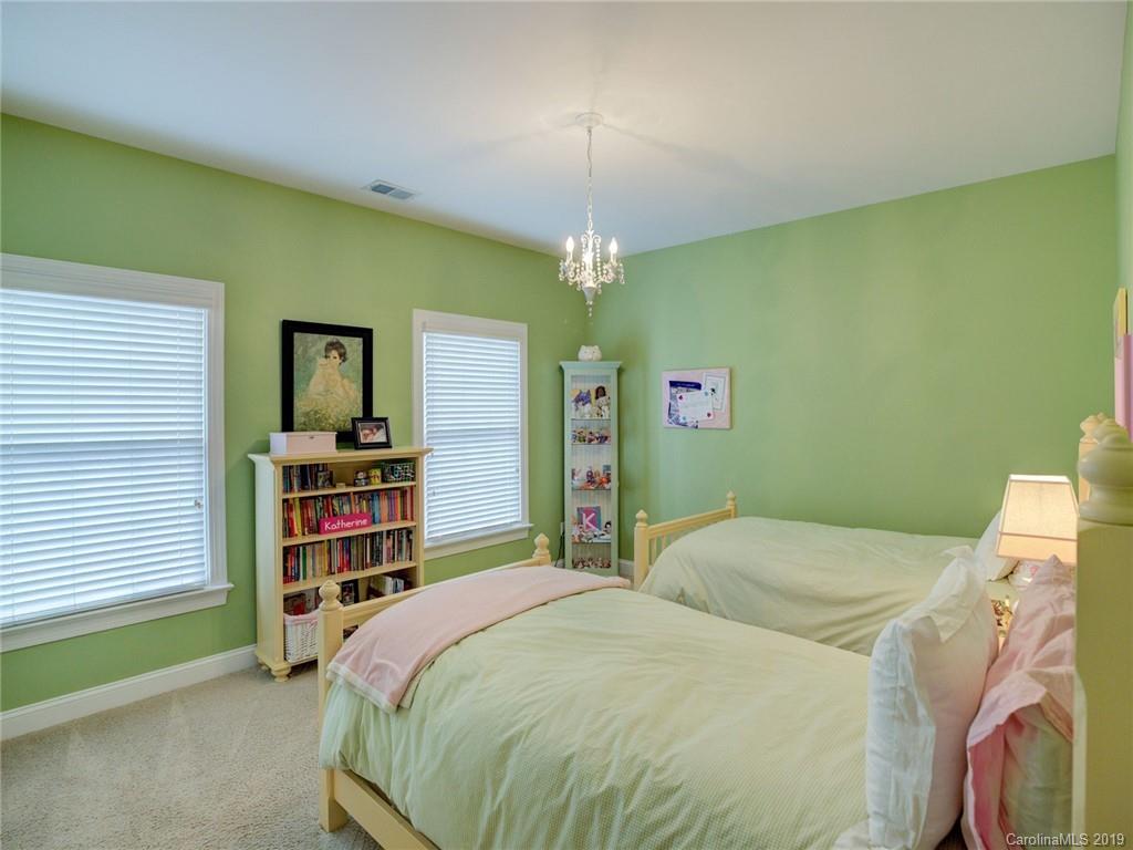1502 Hubbard Court Fort Mill, SC 29708 - Photo 25 of 36 a bedroom with a bed and a book shelf