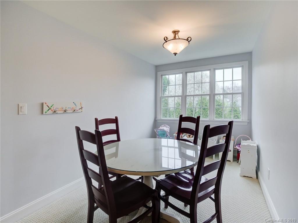 1502 Hubbard Court Fort Mill, SC 29708 - Photo 30 of 36 a view of a dining room with furniture and chandelier