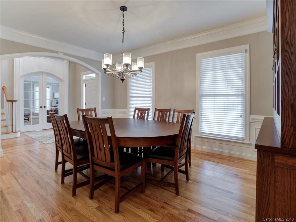 1502 Hubbard Court Fort Mill, SC 29708 - Photo 6 of 36 a view of a dining room with furniture wooden floor and chandelier