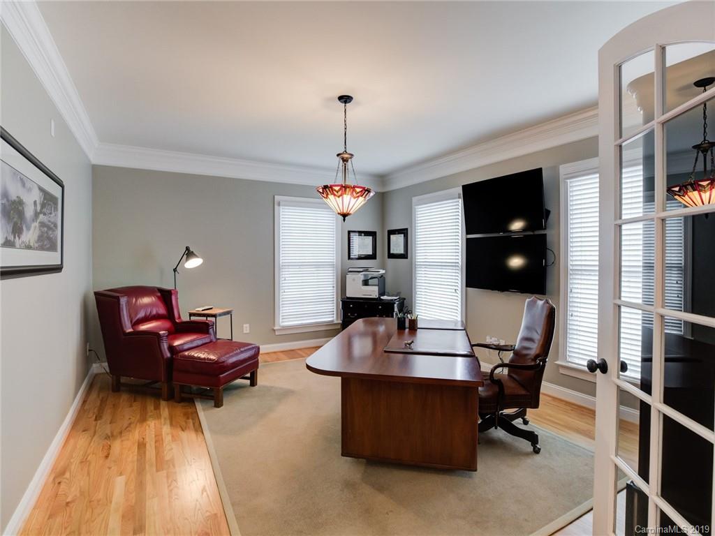 1502 Hubbard Court Fort Mill, SC 29708 - Photo 8 of 36 a living room with furniture a flat screen tv and a chandelier