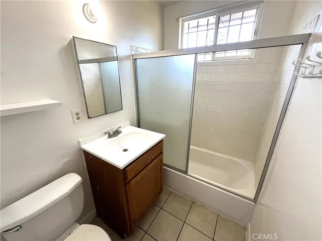 a bathroom with a sink toilet a mirror and shower