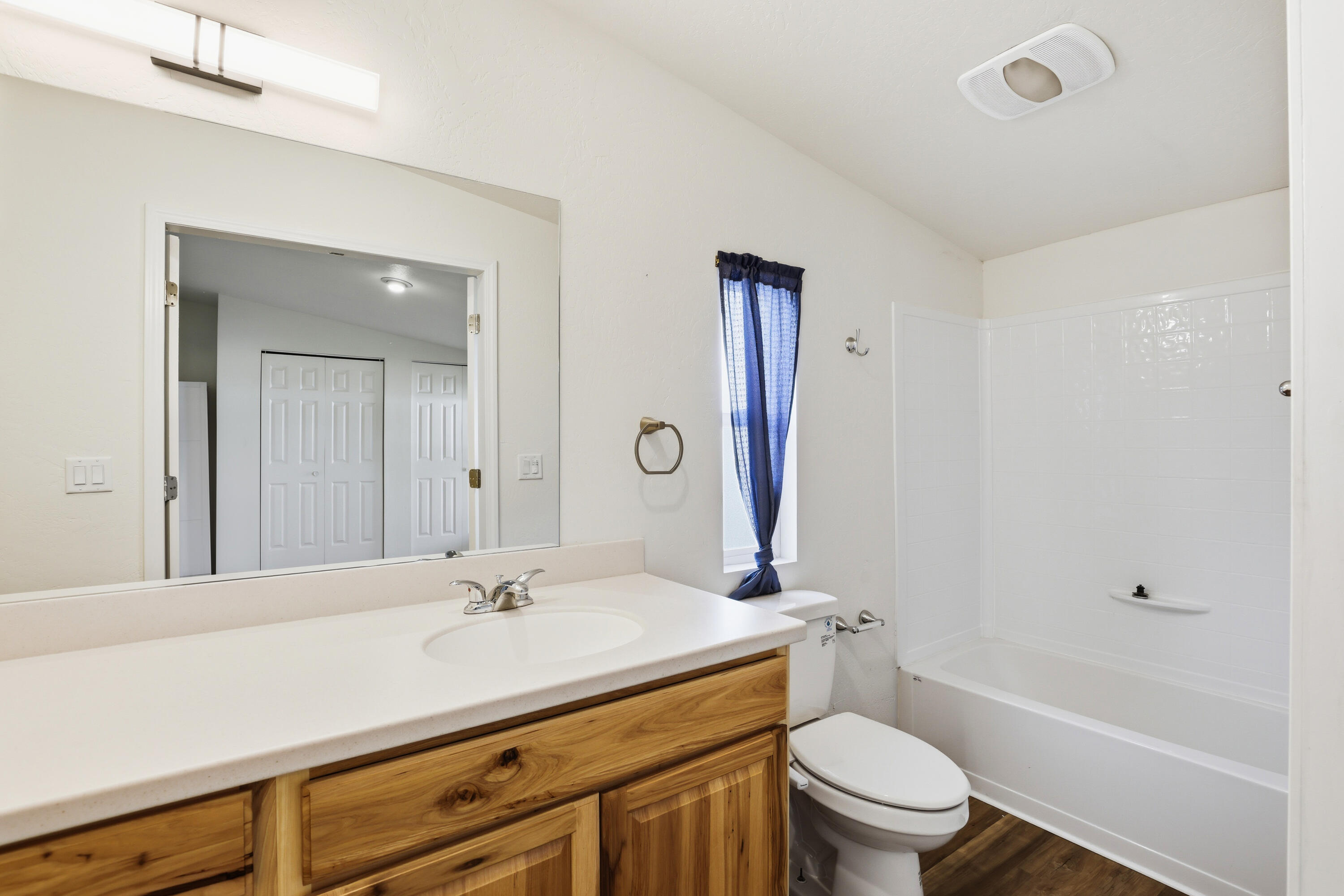 8401 Old Stage Road, Unit 16 Central Point, OR 97502 - Photo 16 of 23 a bathroom with a sink a toilet and a large mirror
