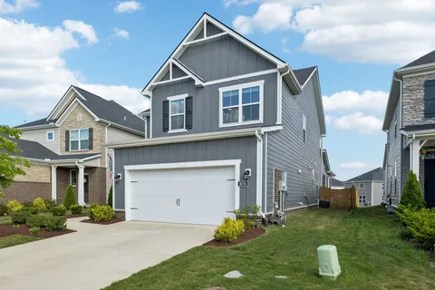 a front view of a house with a yard and garage
