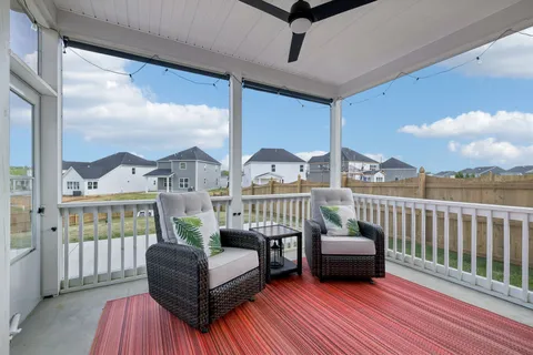 a view of a house with couches chairs and wooden floor