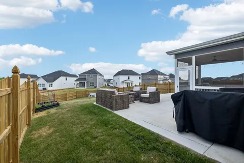 a view of a house with a yard and sitting area