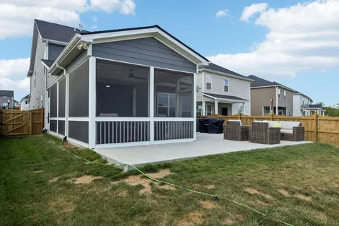 a view of a house with backyard porch and sitting area