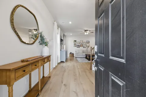 workspace with wooden floor mirror and a bathtub