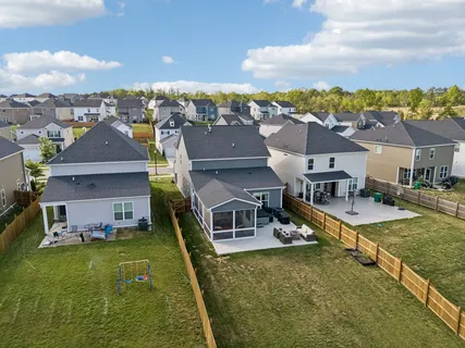 an aerial view of residential houses with outdoor space and swimming pool