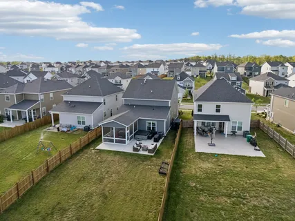 an aerial view of residential houses with outdoor space