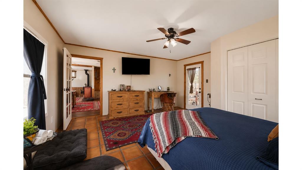 117 Reading Avenue North Center Point, TX 78010 - Photo 15 of 20 Spacious room featuring terra cotta tile flooring, light neutral wall tones, and wood trim details