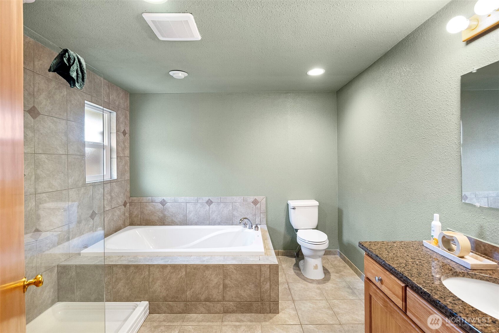 2821 Sanders Avenue Bremerton, WA 98310 - Photo 16 of 40 a bathroom with a granite countertop bathtub sink mirror and toilet