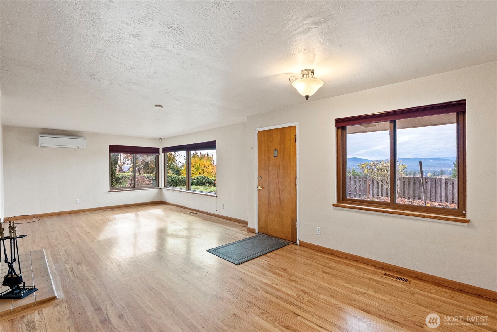 2821 Sanders Avenue Bremerton, WA 98310 - Photo 7 of 40 a view of an empty room with a window and wooden floor