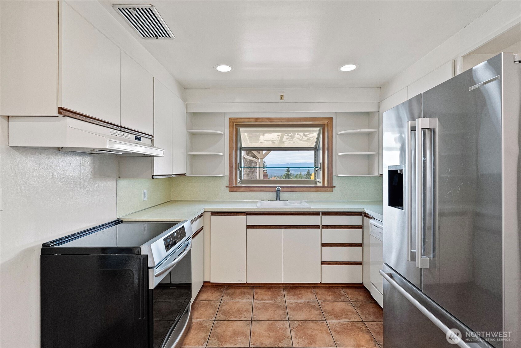 2821 Sanders Avenue Bremerton, WA 98310 - Photo 10 of 40 a kitchen with a sink stove and refrigerator