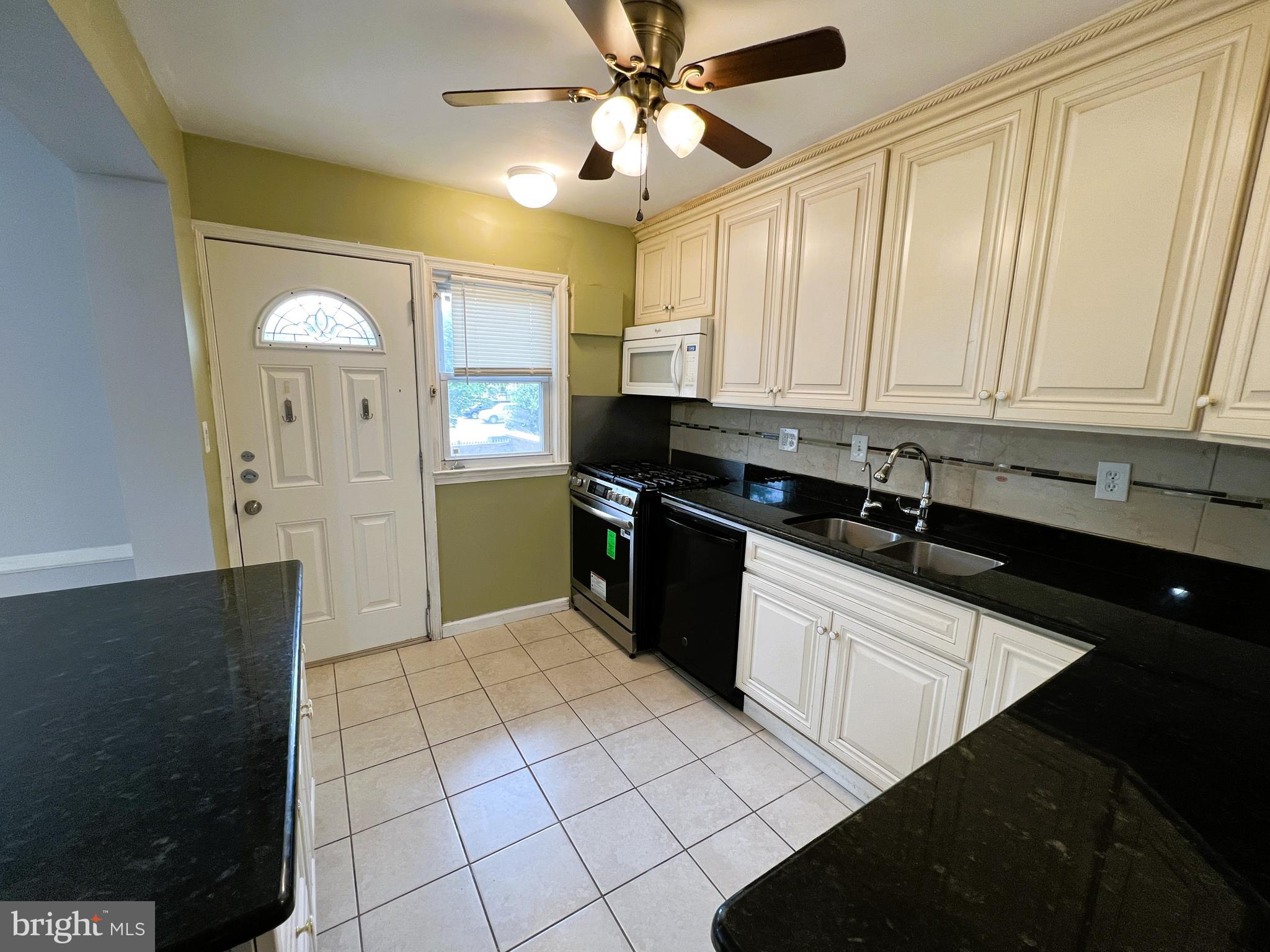 3705 Bancroft Road Baltimore, MD 21215 - Photo 12 of 50 a kitchen with stainless steel appliances granite countertop a refrigerator a sink and dishwasher