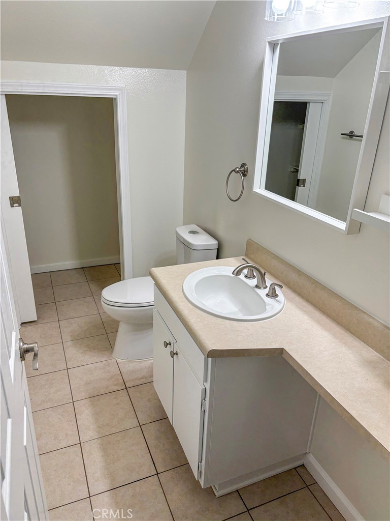 1445 Prefumo Canyon Road, Unit 20 San Luis Obispo, CA 93405 - Photo 11 of 19 a bathroom with a sink a toilet and mirror